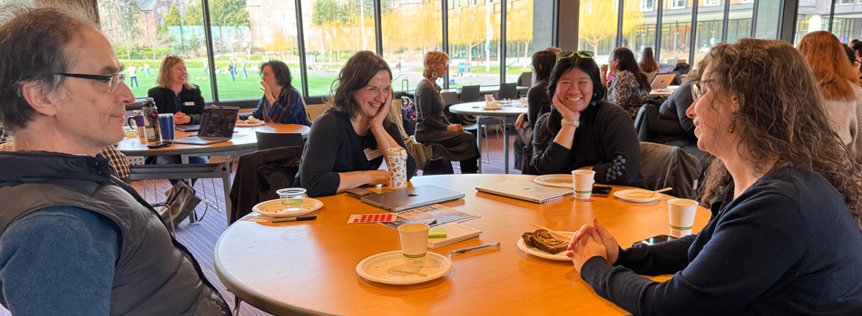 Four people seated around a table during an event.